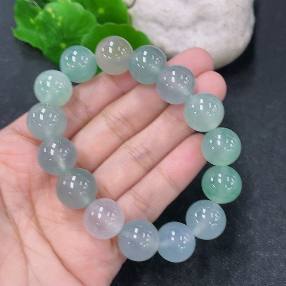 HKHQ jadeite bracelet featuring smooth, rounded beads approximately 13.4mm in size and weighing about 56.13 grams.