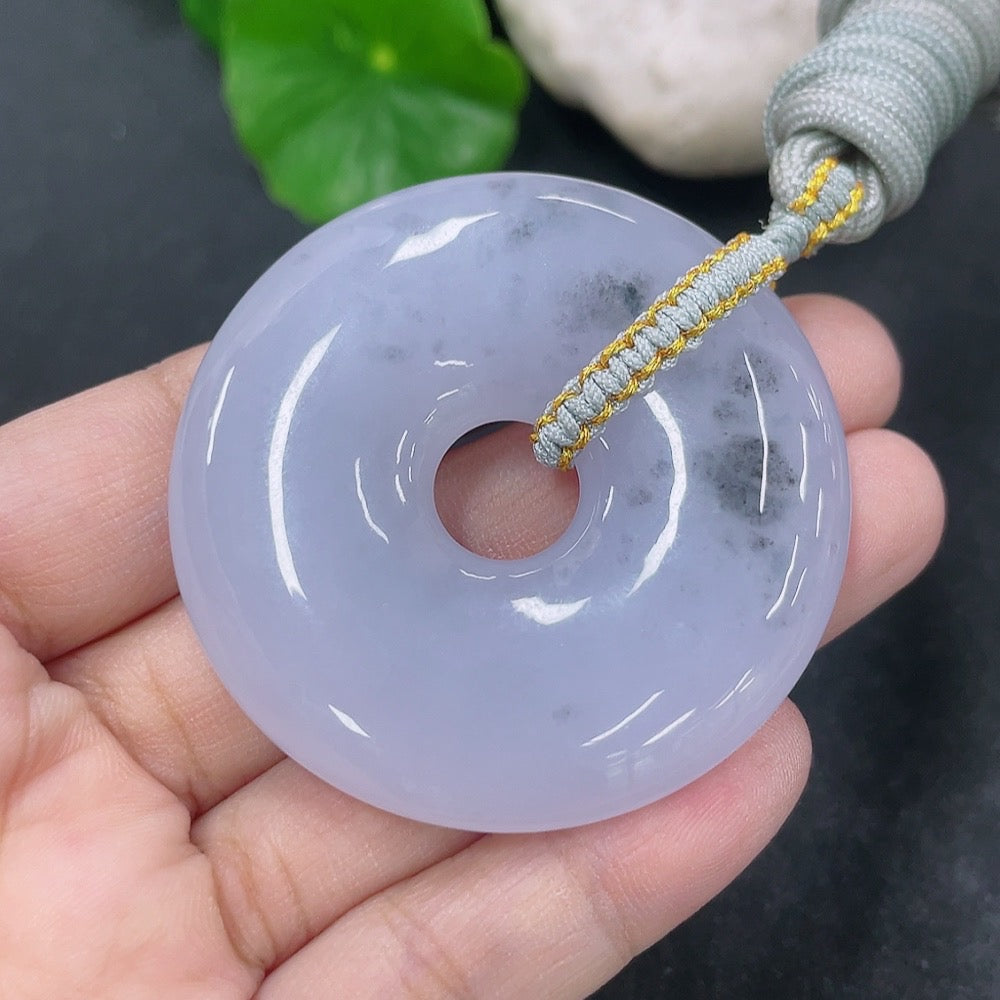 Jadeite pendant donut with rope, weighing approximately 42.54g, featuring a smooth, polished jade surface and natural green color.