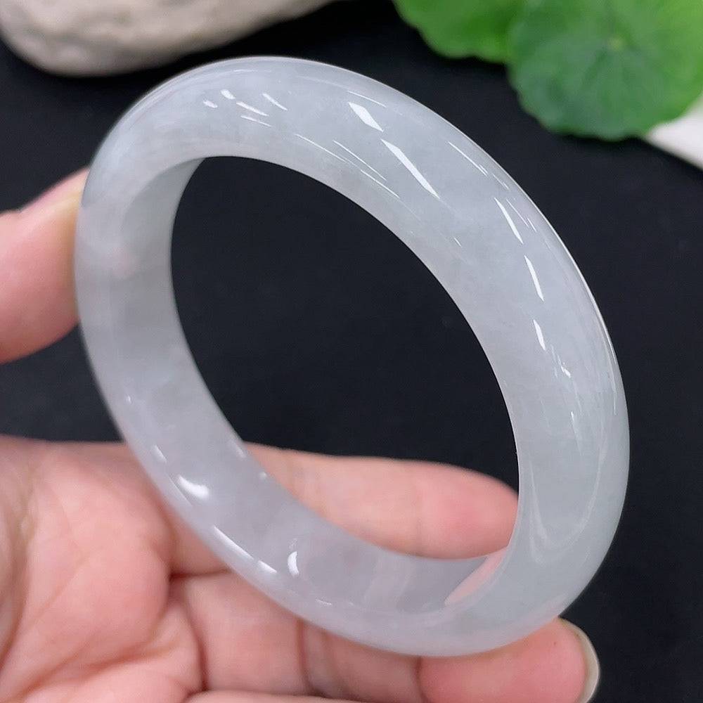 Huiliu Certified Jadeite round bangle showcasing smooth, polished jade with natural green hues on a plain background.