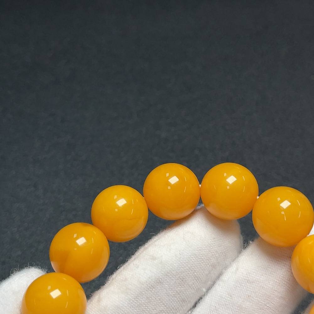Huiliu Certified amber beeswax bracelet with 18.4mm beads, showcasing warm amber tones and natural texture.