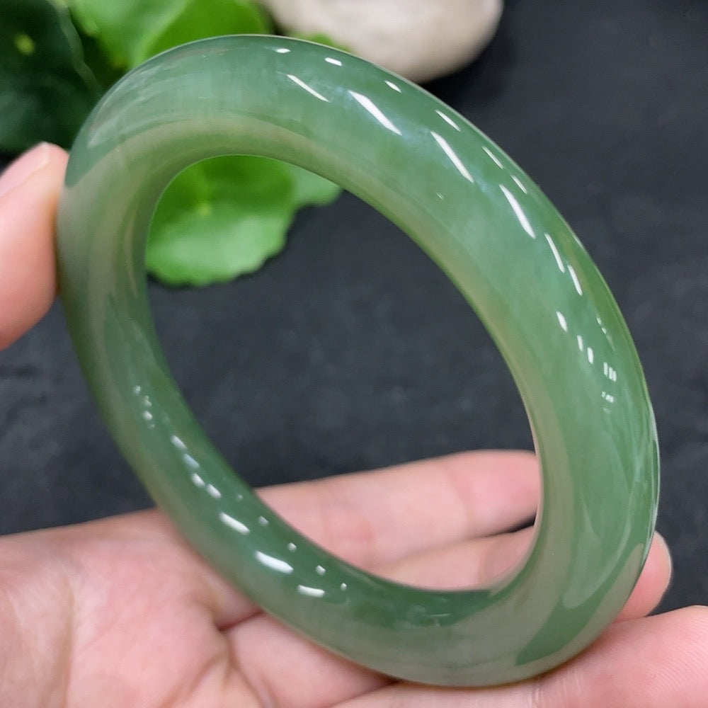 Green Hetian Jade round bangle by HUILIU HQ, 58.6mm size, approximately 65.8g weight, showcasing smooth polished surface.