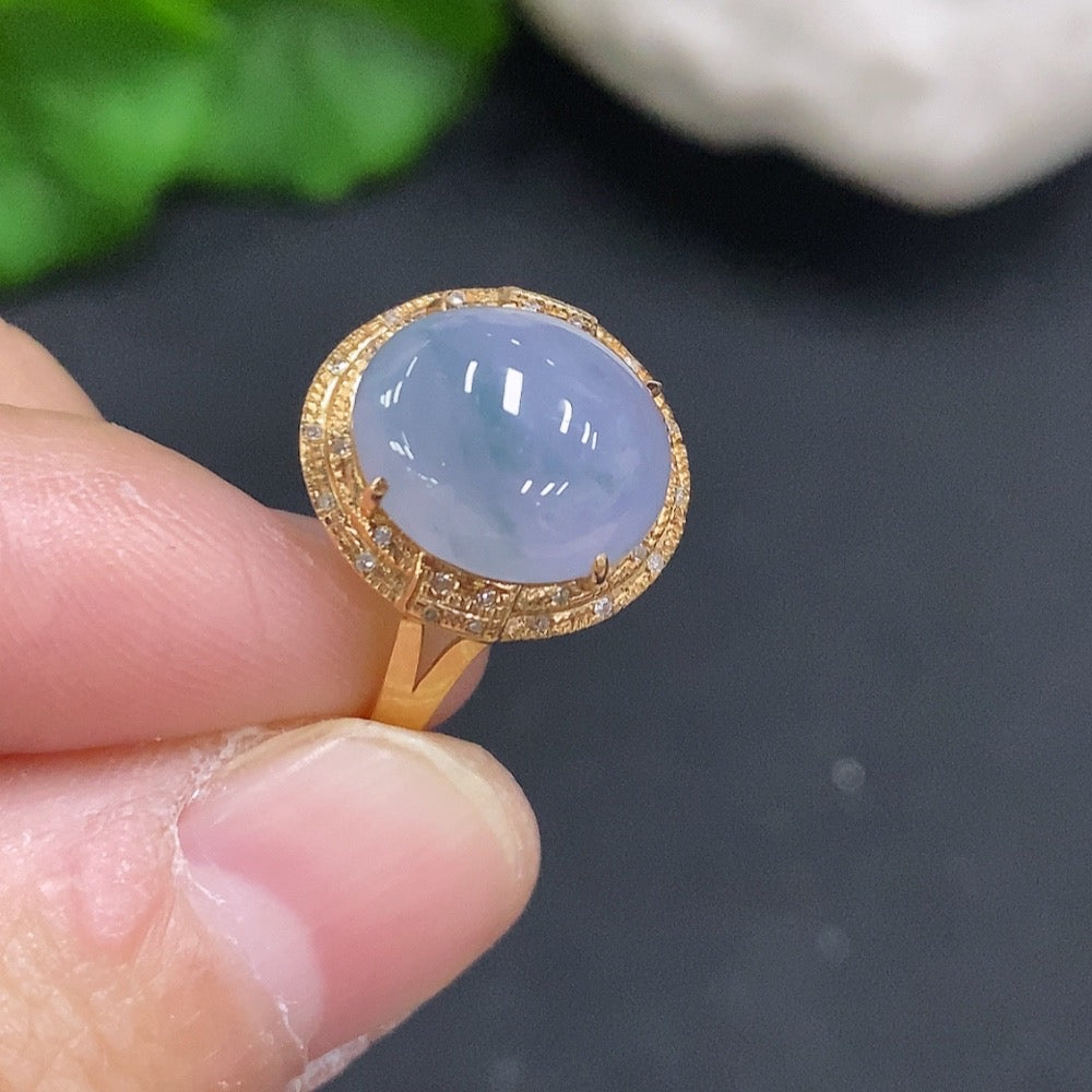 Huiliu certified jadeite cabochon ring accented with small diamonds, showcasing a smooth, polished jade gemstone in a gold setting.
