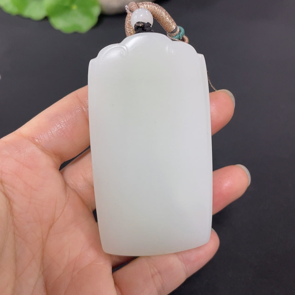 Huiliu certified Hetian jade pendant with plain design and attached rope, showcasing smooth, polished jade craftsmanship.