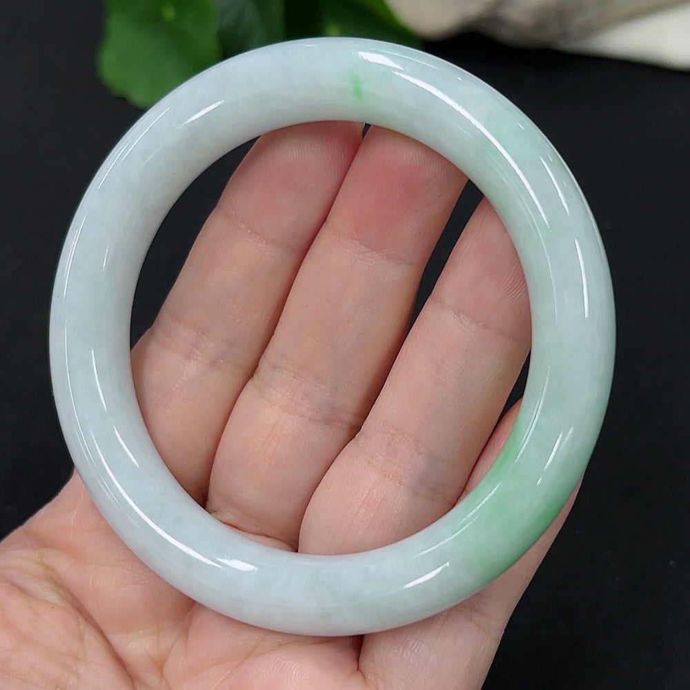 HKHQ jadeite round bangle in size 55, weighing 58.4g, showcasing smooth, polished green jadeite bracelet on a plain background.
