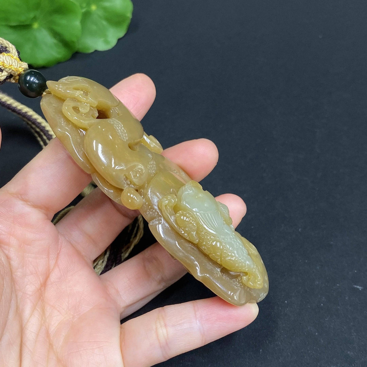Huiliu HQ Hetian Jade handheld carving of a three-legged golden toad, detailed and polished jade sculpture.