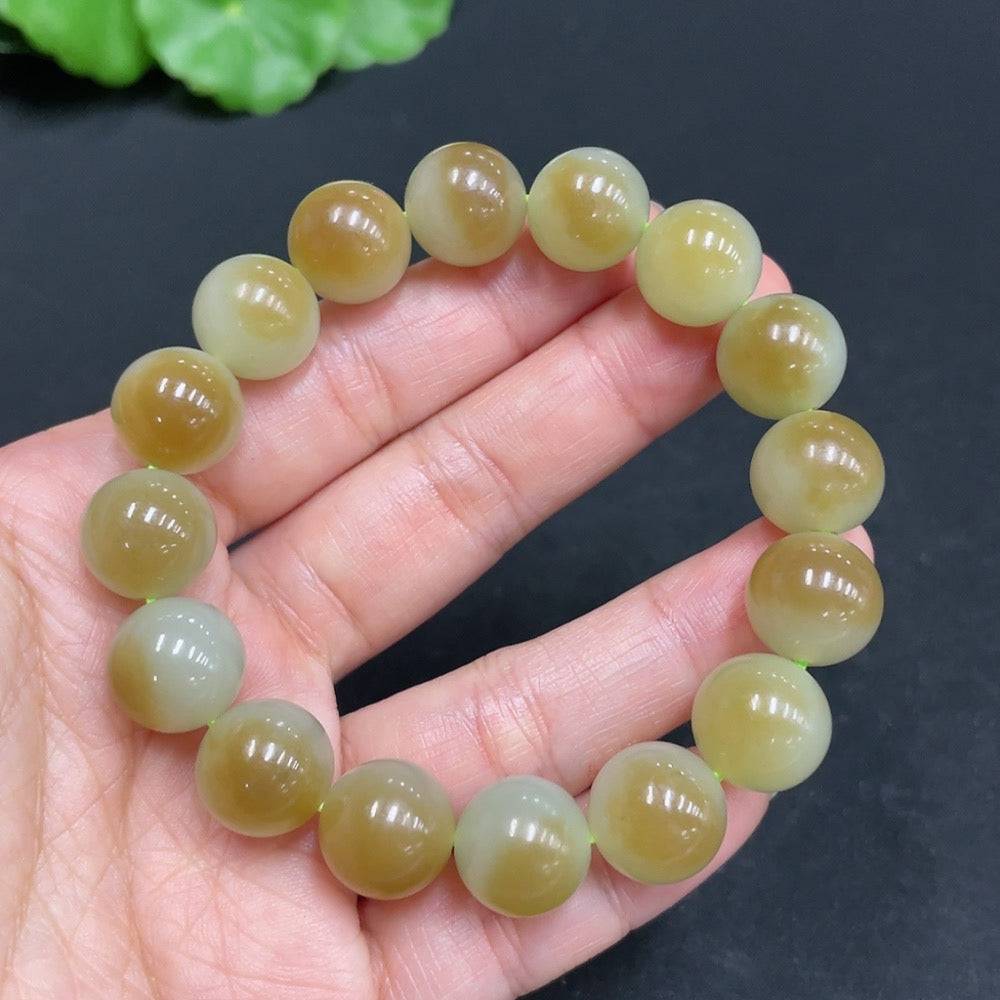 Hetian jade bracelet by HUILIU HQ featuring 11.9mm beads, weighing approximately 41.7g, showcasing smooth, polished jade stones.
