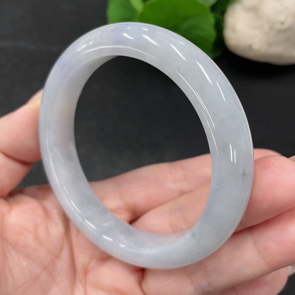 HUILIU HQ jadeite round bangle in size 55.7, weighing approximately 57.52g, showcasing smooth, polished green jade jewelry.