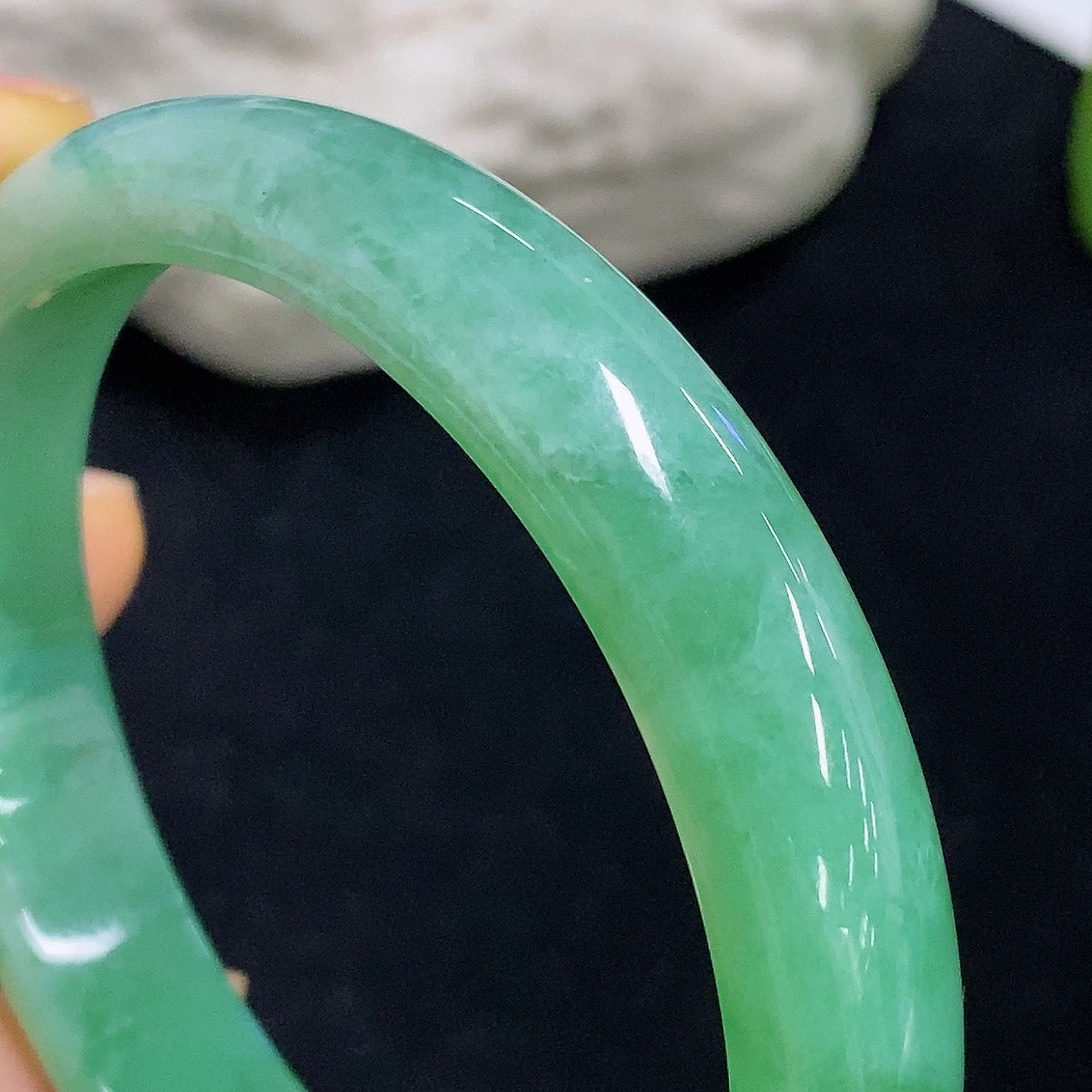 HKHQ jadeite oval bangle in size 56.2, 38.3g, showcasing smooth, polished jadeite with elegant oval shape and vibrant green hue.