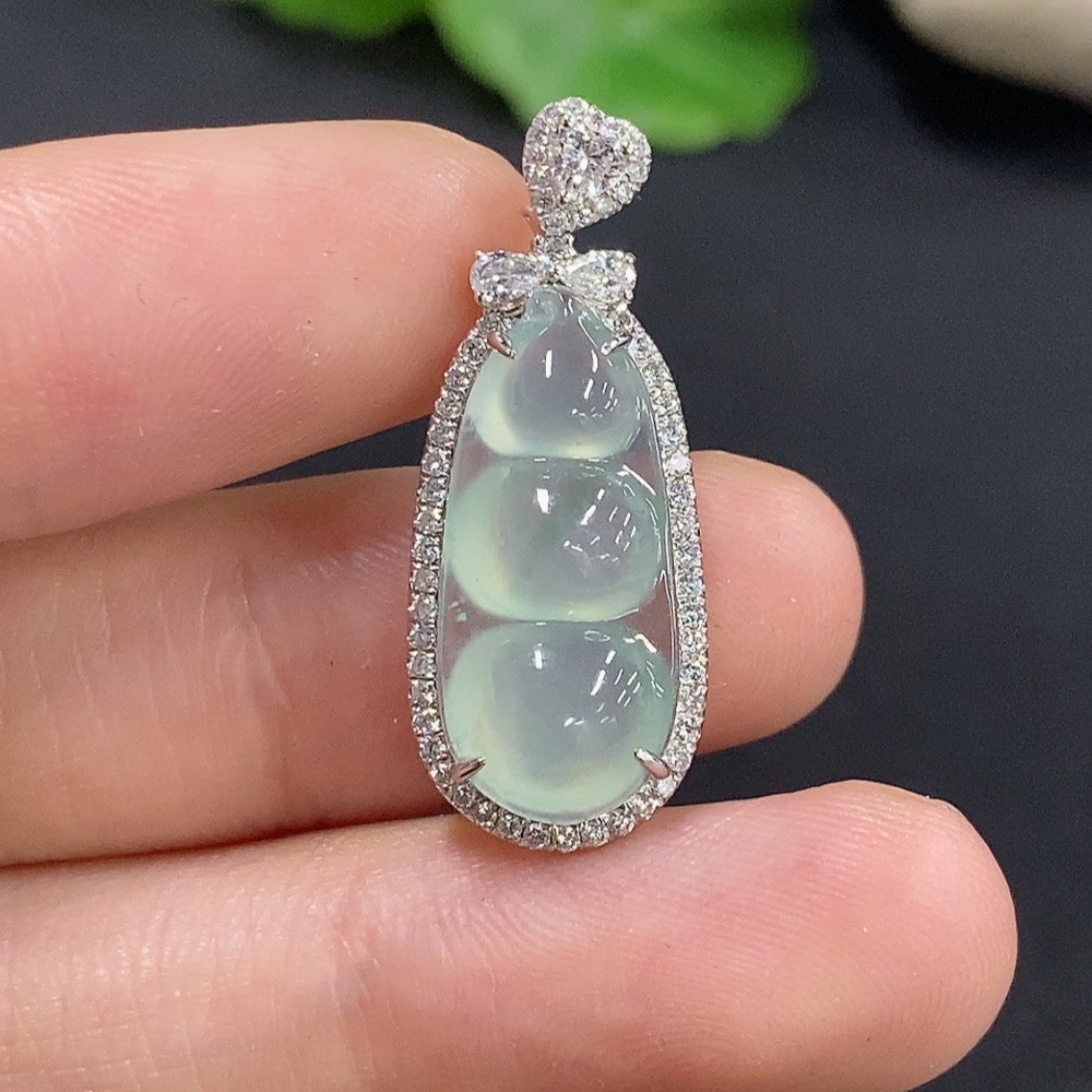 Jadeite lucky bean inlaid pendant with 18k gold setting, showcasing intricate craftsmanship and vibrant jade color.