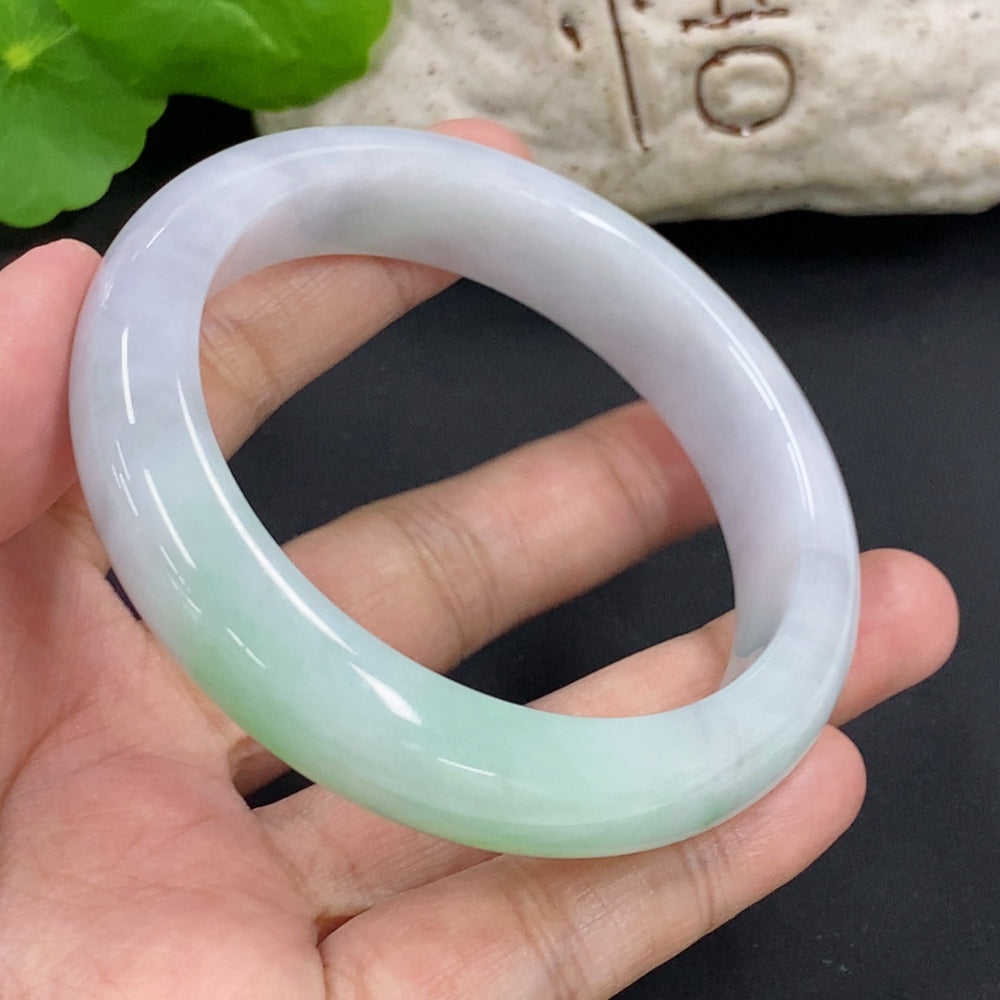 HKHQ Jadeite round bangle in size 57.1 with a 64.6g weight, featuring smooth, polished jadeite surface and rounded shape.