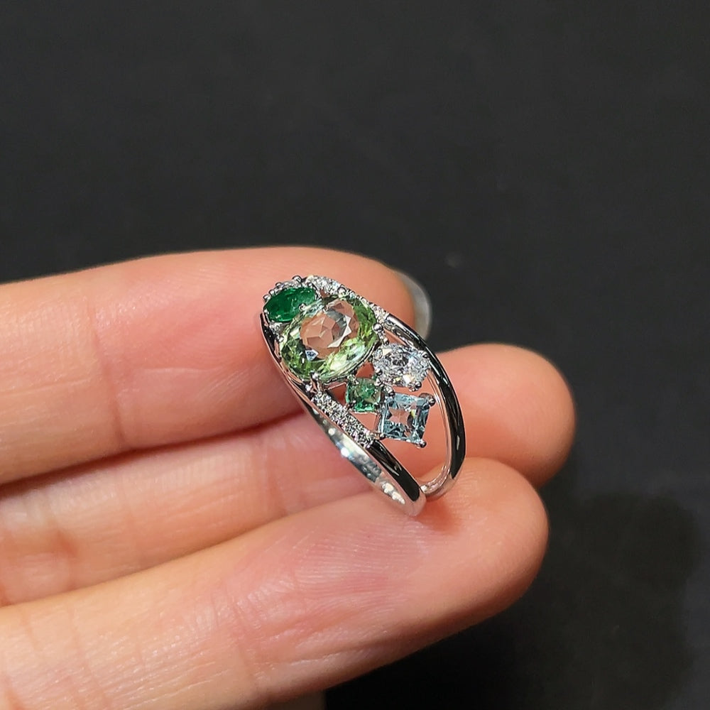 HKHQ gemstone tourmaline ring featuring a large, vibrant tourmaline stone set in a detailed metal band, showcasing elegant jewelry design.