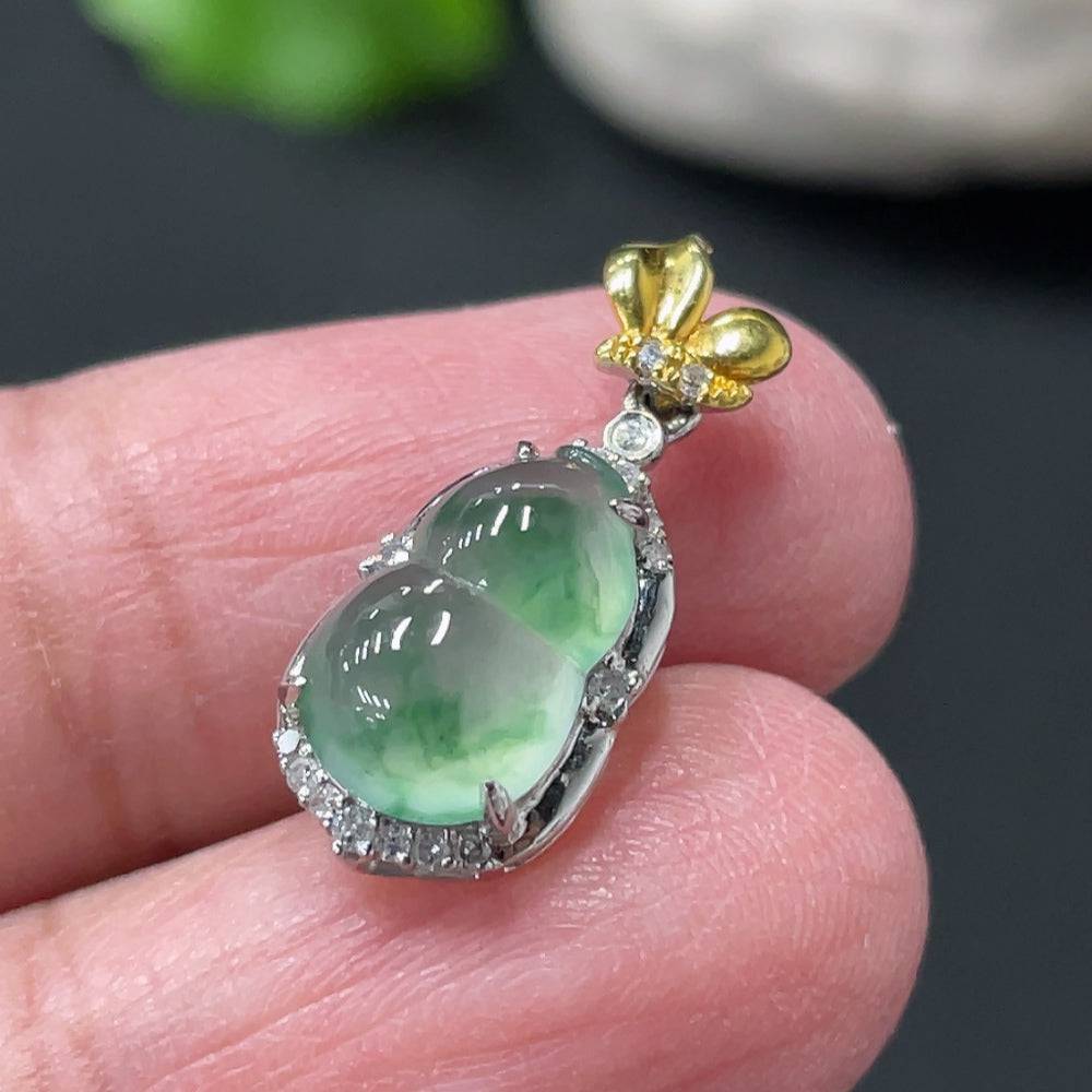 Jadeite gourd pendant with 18k gold accents and diamond details, intricate jade craftsmanship, weighs approximately 1.45g.