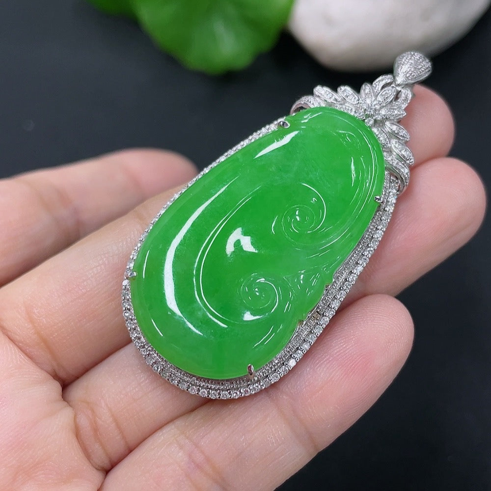 Jadeite inlaid Ruyi pendant with 18K gold and diamonds, showcasing intricate craftsmanship and elegant design.