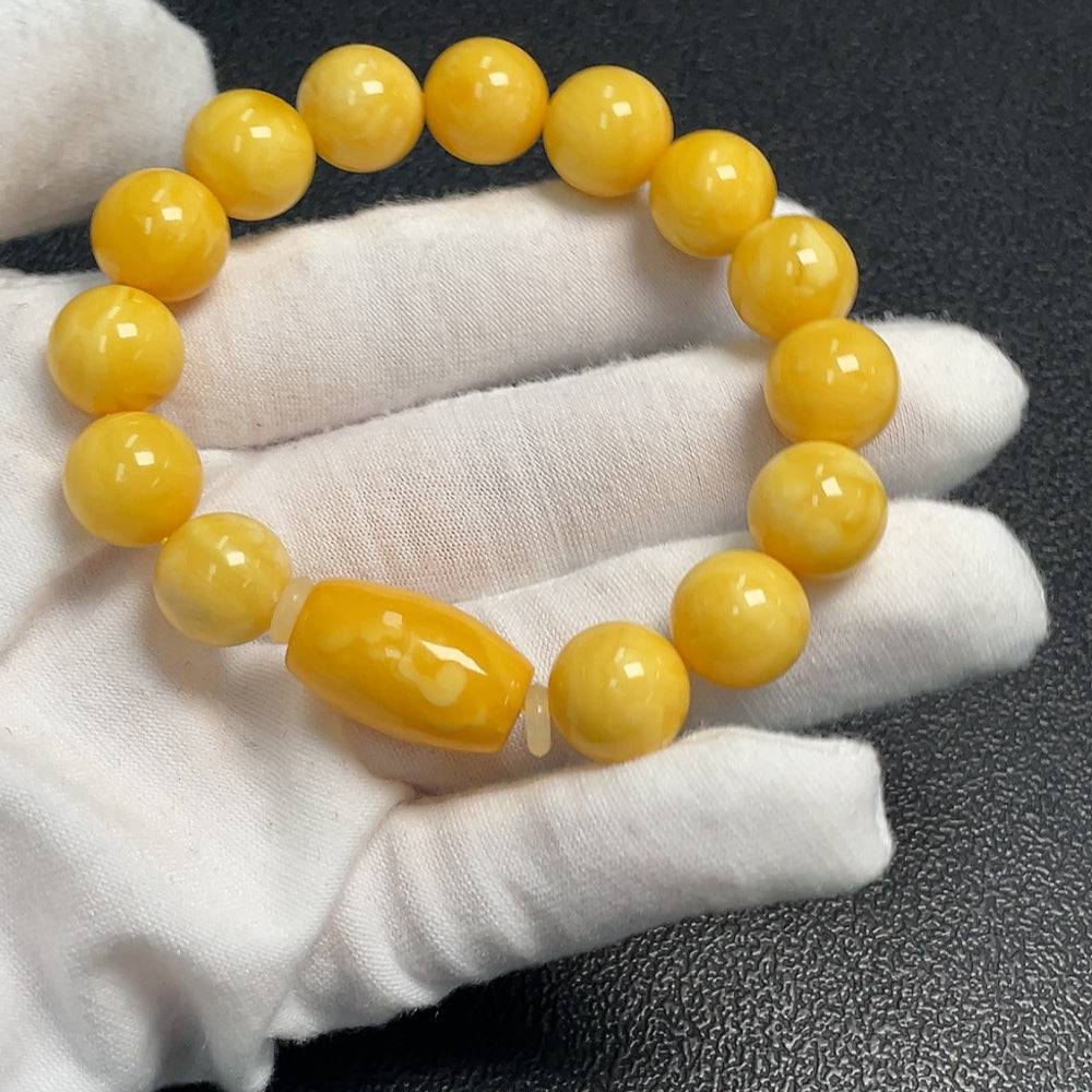 Huiliu Amber Beeswax bracelet featuring 11.5mm amber beads with natural warm tones, handcrafted for a stylish look.