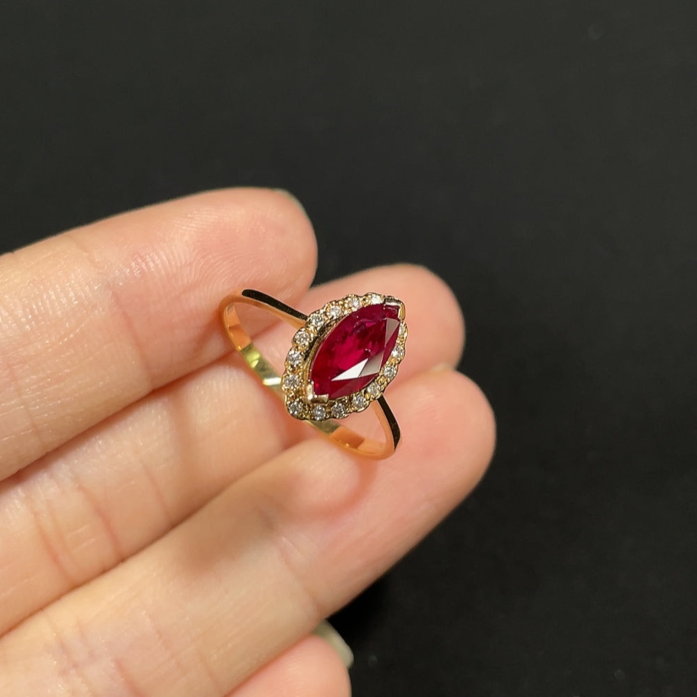 18K gold Ruby ring with diamond accents, elegant jewelry piece featuring vibrant red gemstones and sparkling diamonds.