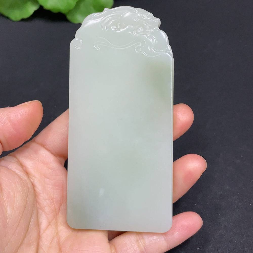 Huiliu certified Hetian jade Guanyin pendant featuring intricate carved design on smooth, polished jade stone.