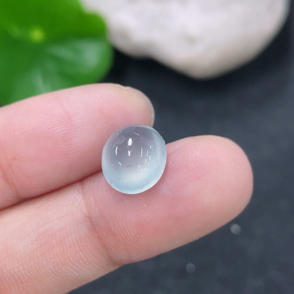 Jadeite cabochon jewelry piece from HKHQ, weighing 0.71g, featuring smooth, polished green gemstone with natural luster.