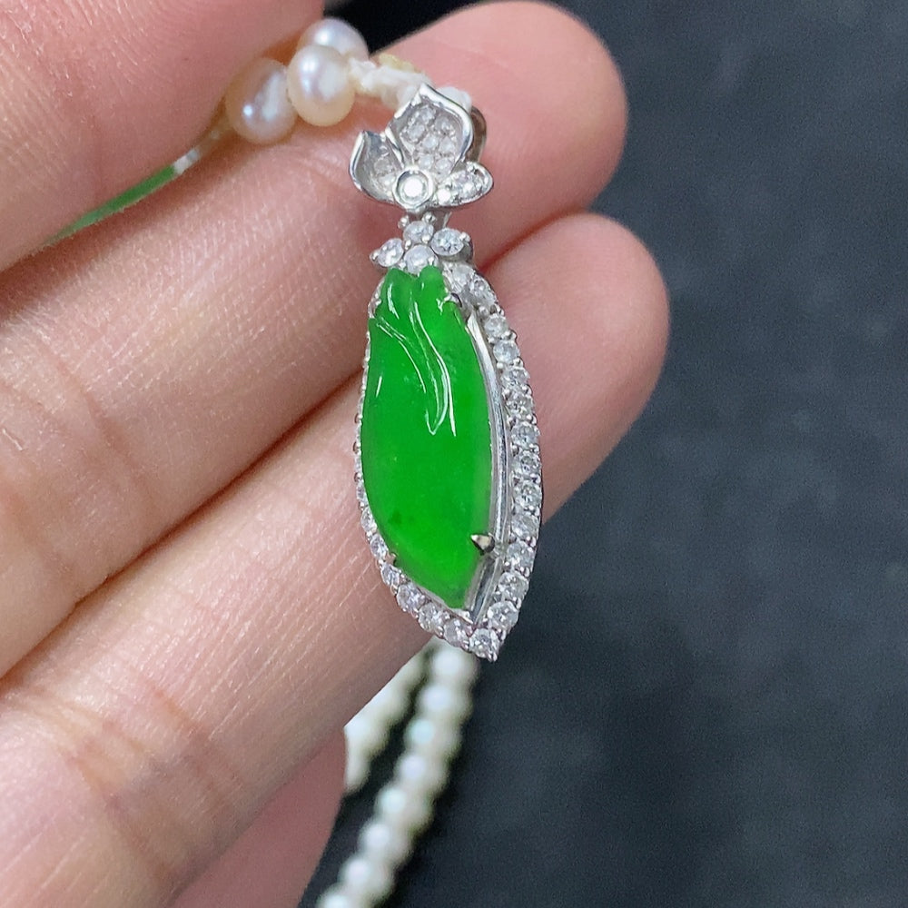 Jadeite freeform inlay pendant with 18K gold accents, mounted on a non-gold chain, showing intricate jade design and gold details.