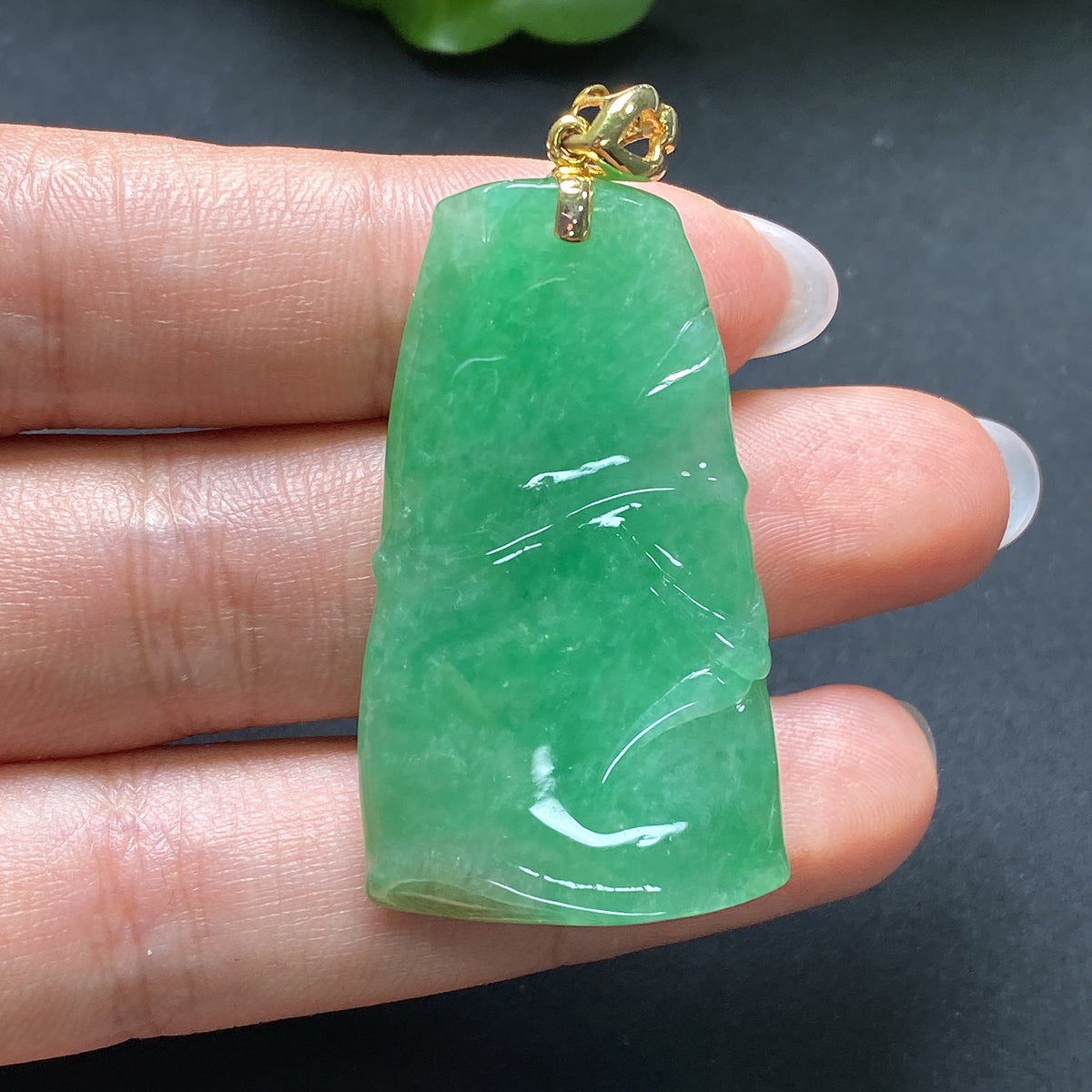 Jadeite pendant featuring bamboo design in 18K gold setting, by HKHQ, showcasing a polished green jade pendant with intricate bamboo details.