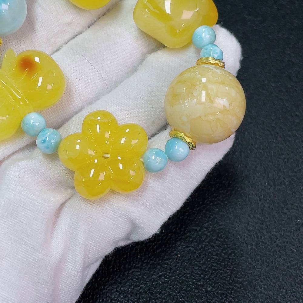 Amber beeswax bracelet with larimar gemstone from HUILIU HQ, featuring organic matter and natural amber beads.