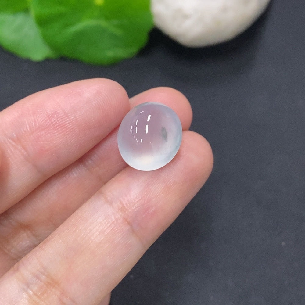 Jadeite cabochon jewelry by HKHQ, 2.2g, smooth polished green gemstone with natural variations and a rounded, glossy surface.