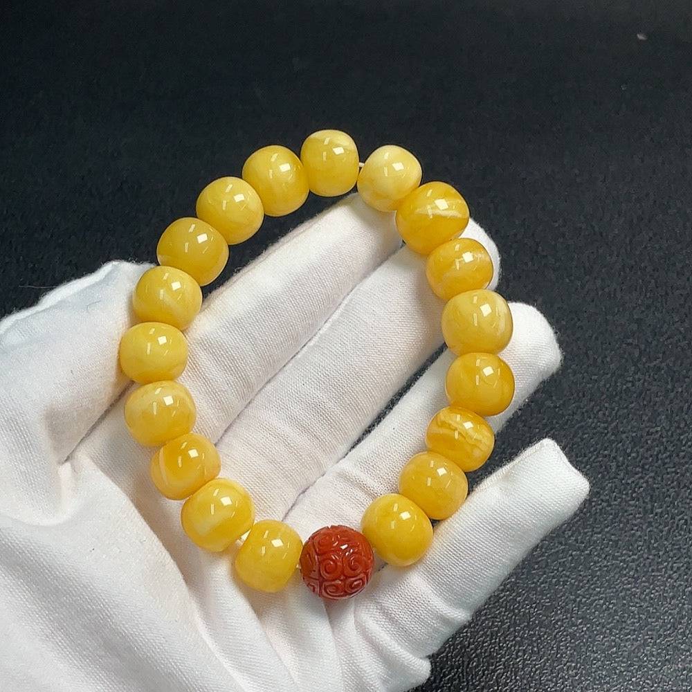 Amber beeswax bracelet with Southern Red Agate beads, approximately 12.7mm, by HUILIU HQ, featuring warm amber and vibrant red stones.