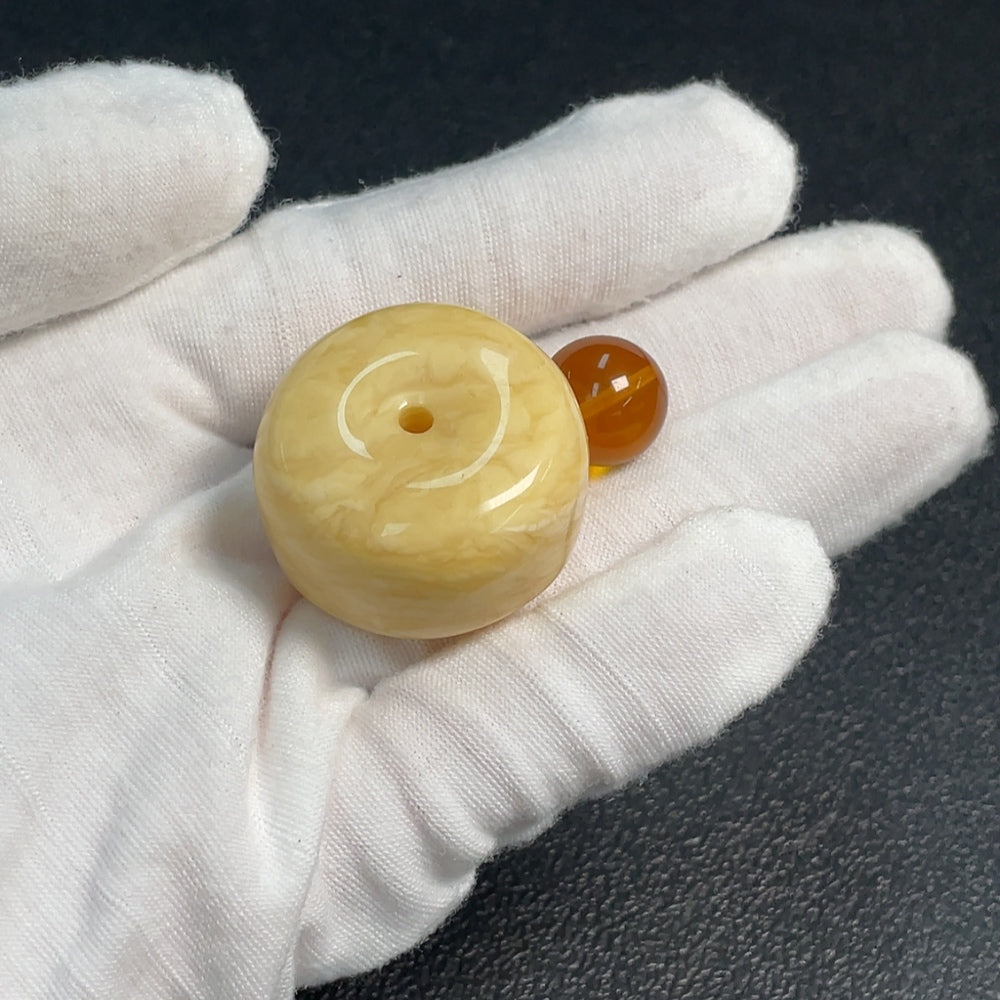 HUILIU HQ Amber beeswax pendant, handcrafted jewelry with warm amber color, showcasing natural textures and polished finish.