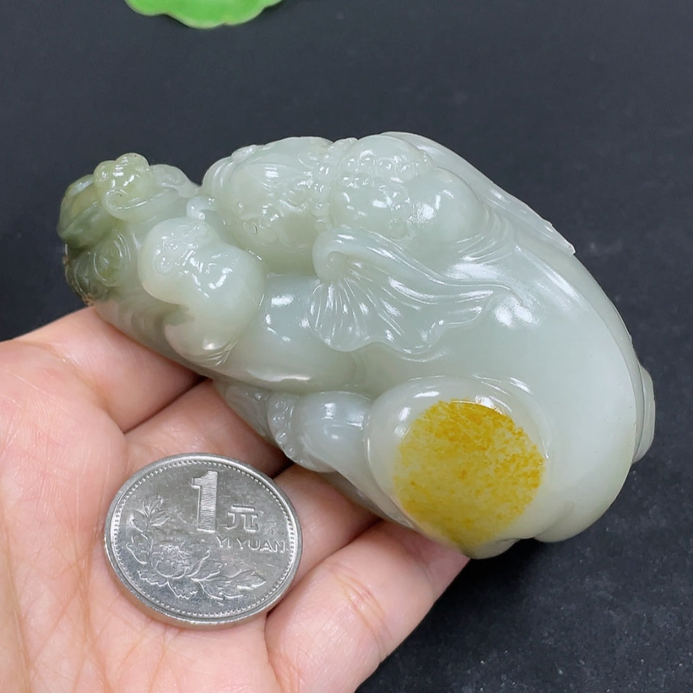 Close-up of Hetian Jade seed material hand piece by HKHQ, showcasing smooth jade surface and natural green hue.