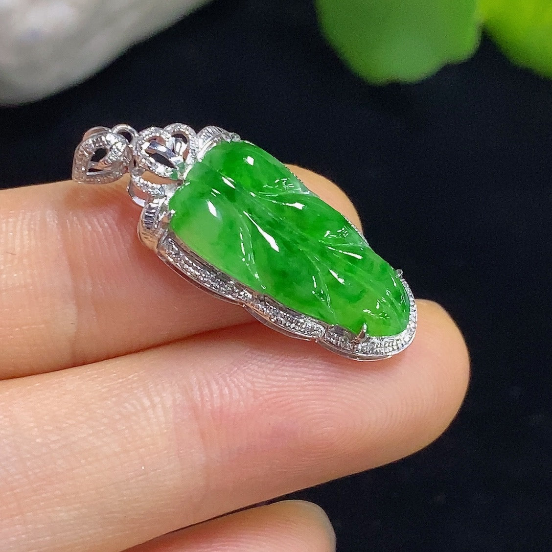 Jadeite leaf inlaid pendant with 18k gold and diamond accents, featuring detailed leaf design, weighing approximately 2 grams.