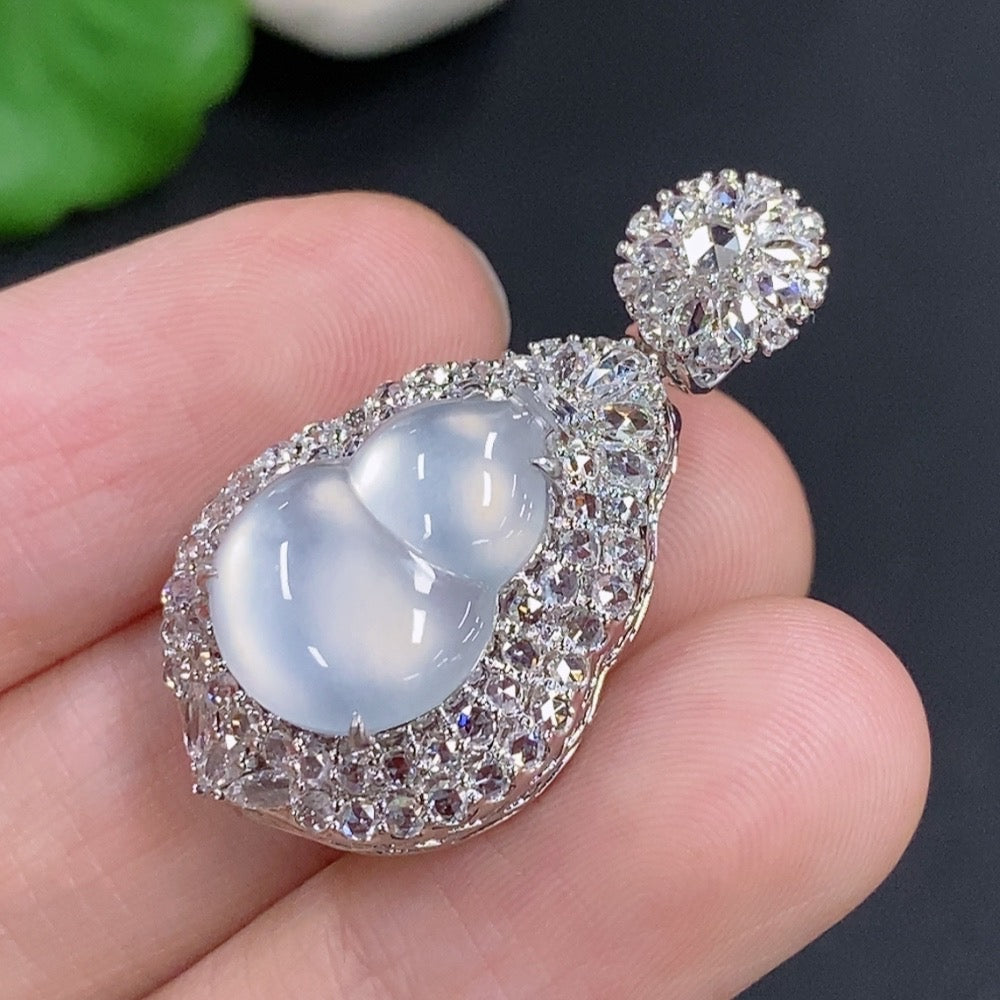 Jadeite gourd pendant with diamond accents in 18k gold, displayed on a necklace chain, showcasing intricate craftsmanship and elegant design.