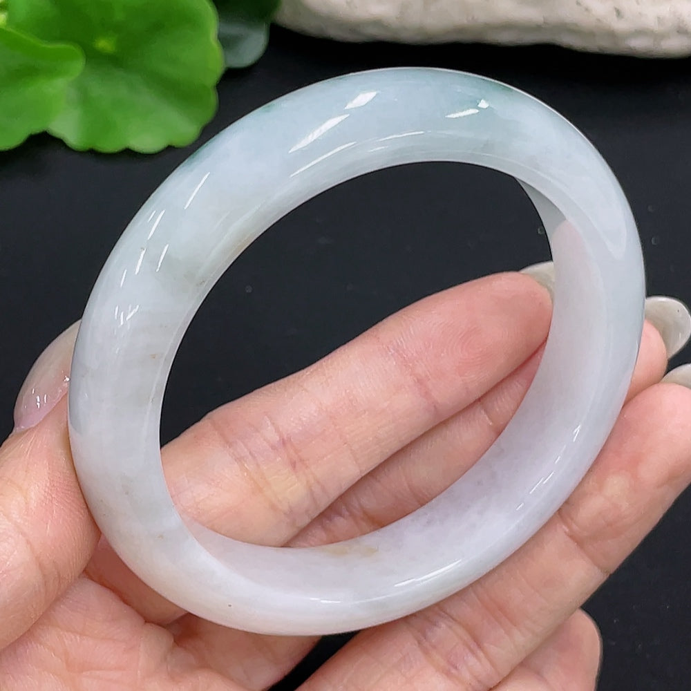 Jadeite round bangle with size 55.1 and weight 55.3g, showcasing smooth, polished jadeite surface in a close-up view.