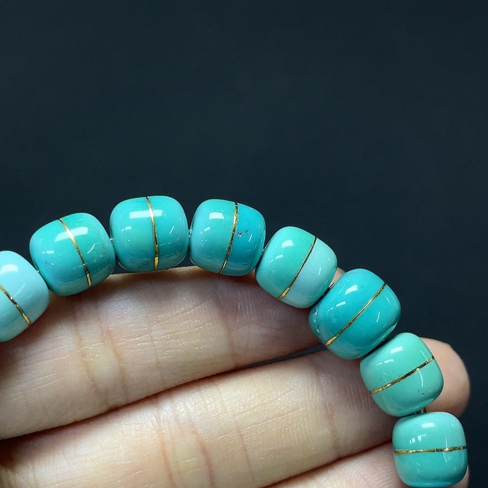 Turquoise gemstone bracelet with gold content and stone inclusions, weighing about 26.98g, featuring 8.9-10.7mm stones.