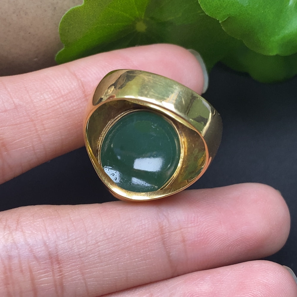 Elegant jadeite ring with 18k gold band from HKHQ showcasing a polished green jadeite gemstone.