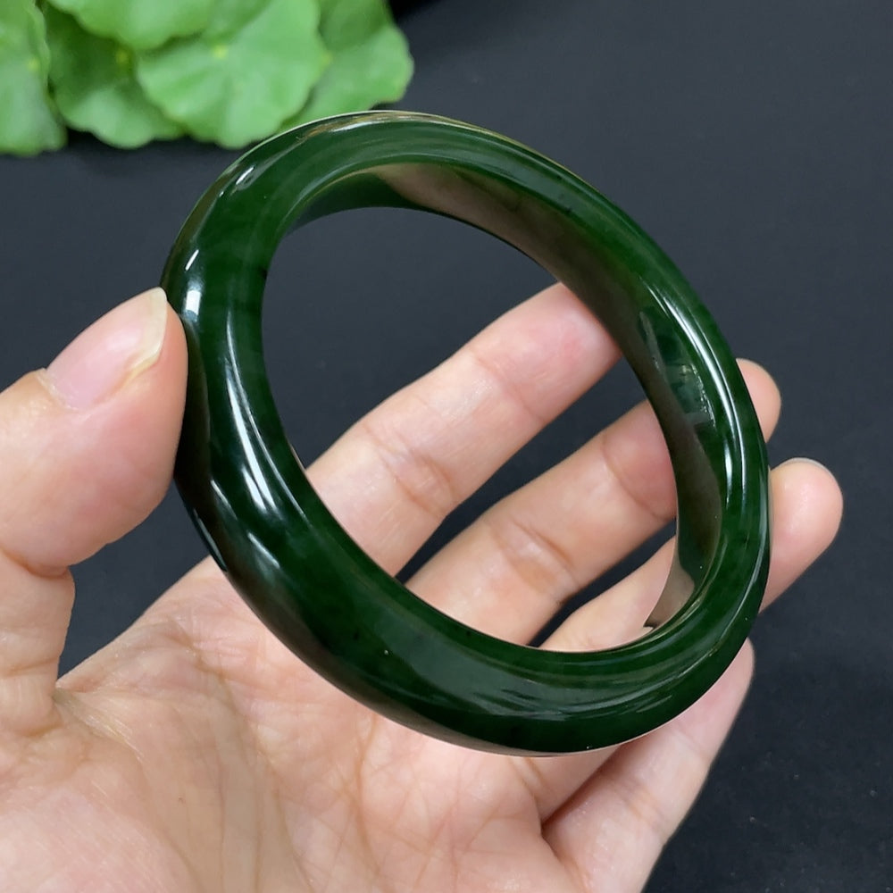 Green Hetian Jade round bangle bracelet from HKHQ, smooth polished jade with a circular shape and vibrant green color.