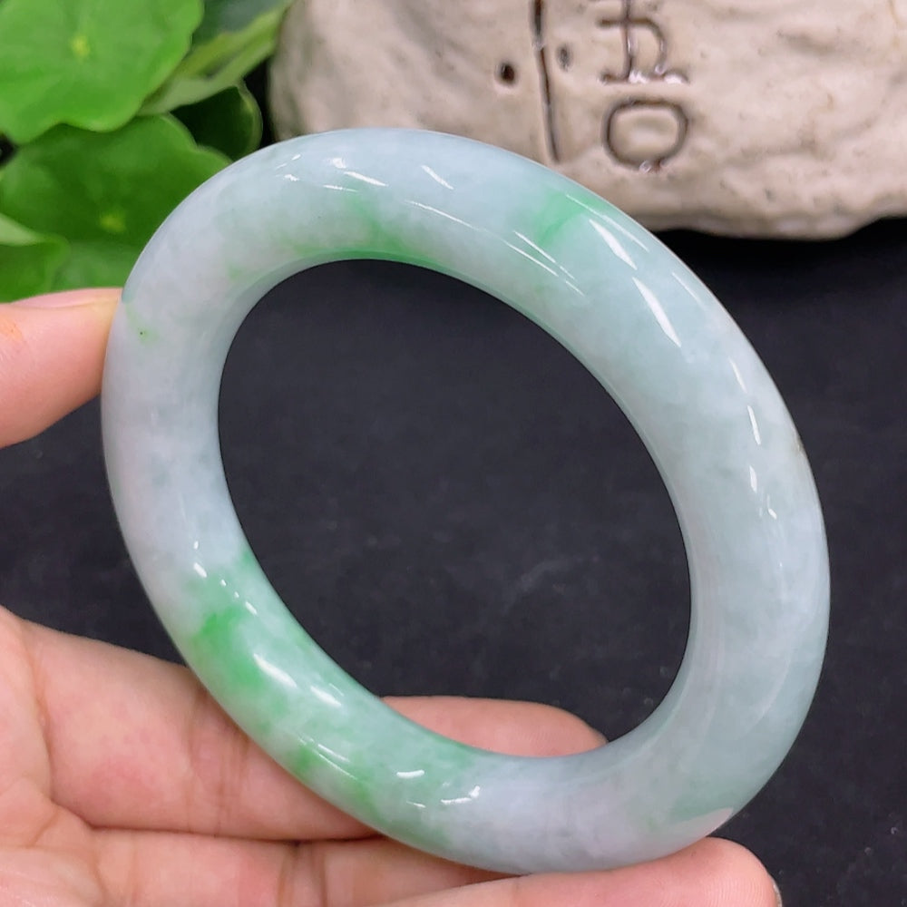 Jadeite round bangle from HKHQ, approximately 80.5g, size 56.2, featuring smooth, polished jade surface and rounded design.