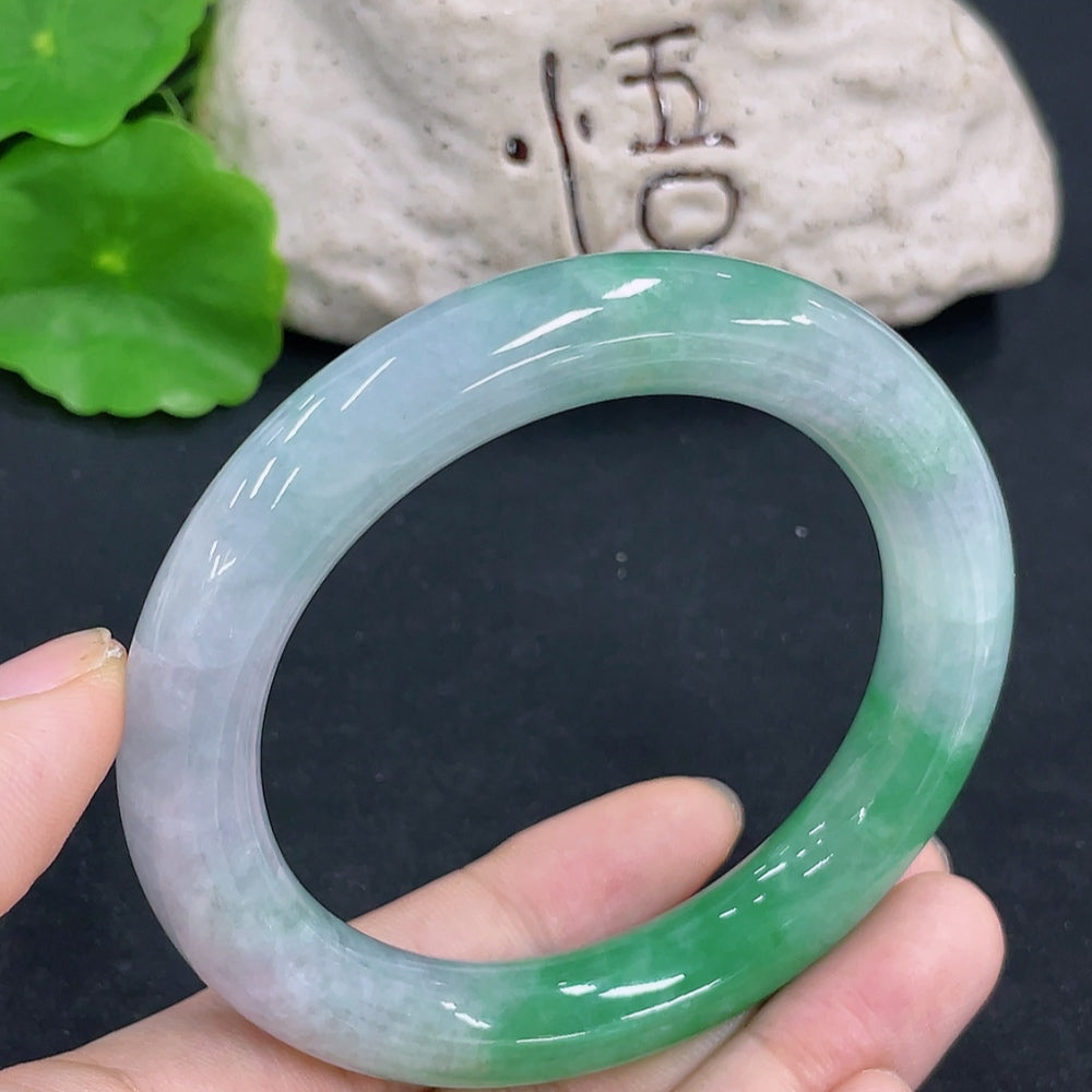 HKHQ jadeite round bangle, 64.9g, size 55.8, showcasing smooth, polished green jade with a glossy finish.
