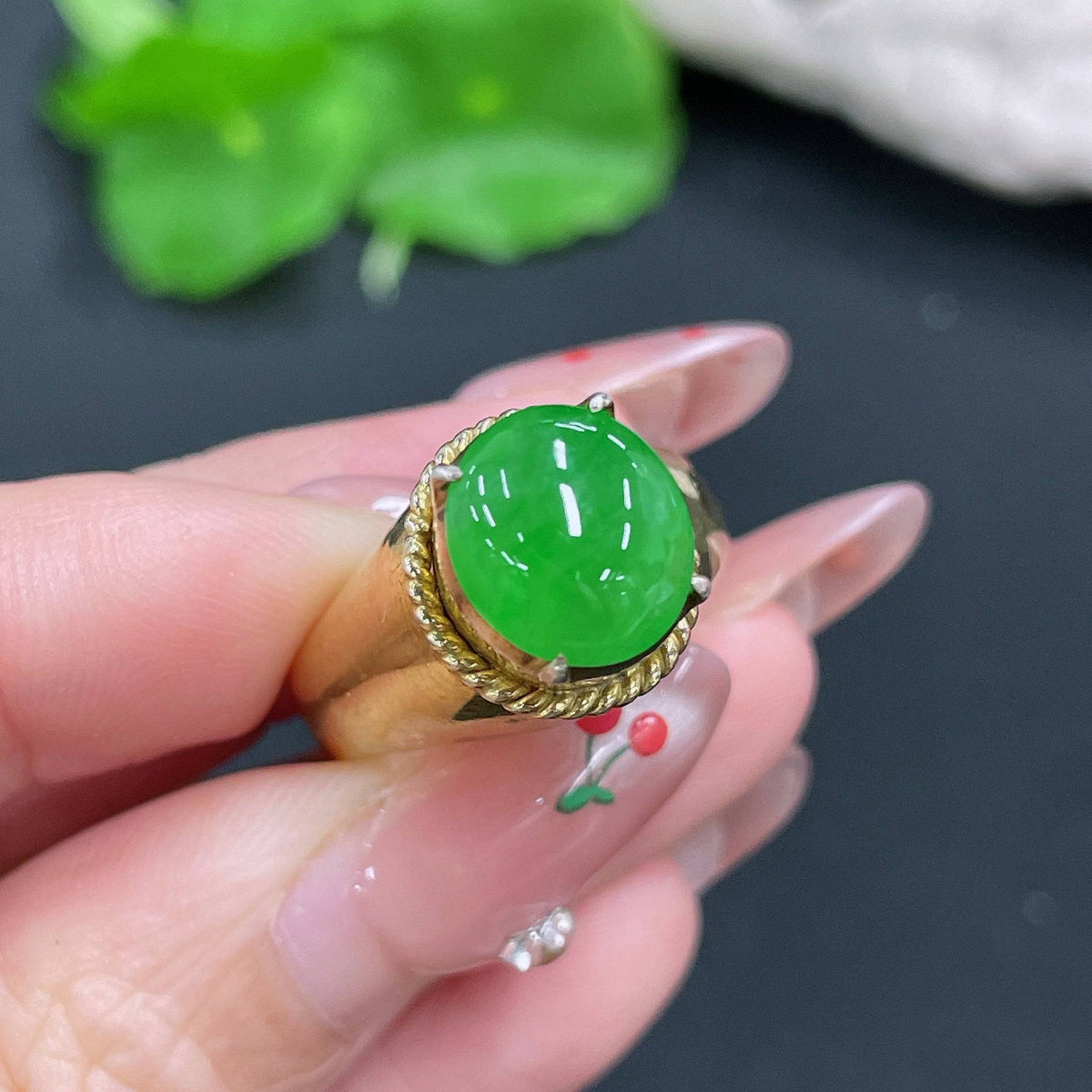 HUILIU HQ jadeite cabochon weighing about 12.26g, smooth polished jade gemstone with vibrant green hue and natural luster.