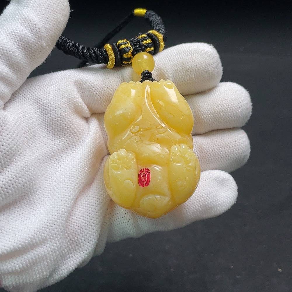 Huiliu Amber beeswax pendant with rope cord, natural amber jewelry, handcrafted HUILIU HQ accessory, close-up view