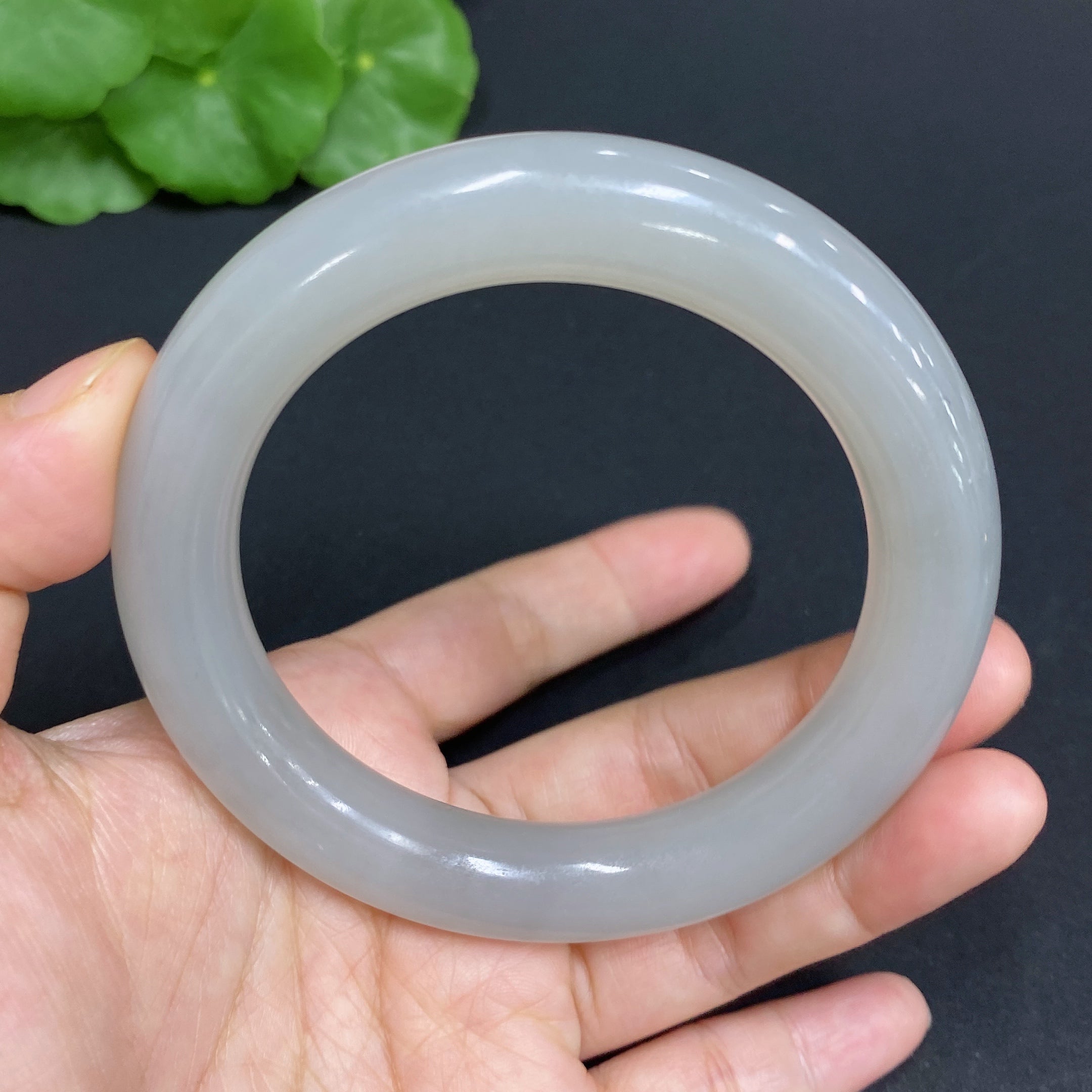 Huiliu certified Hetian jade round bangle, 58.3mm, showcasing smooth, polished jade with natural green and cream tones.