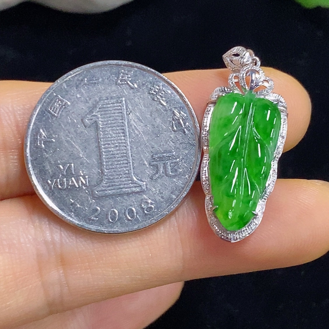 Jadeite leaf inlaid pendant with 18k gold and diamond accents, featuring intricate leaf design and shimmering details.