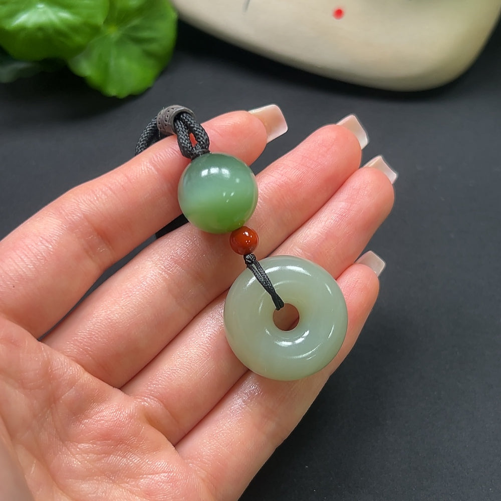 Hetian jade peace knot pendant with southern red accents, weighing 22.9g, featuring a rope chain, by HKHQ.