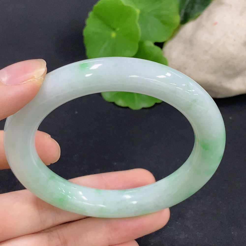 HKHQ Jadeite round bangle, size 56, showcasing smooth, polished jade with a total weight of 62.4g, on a neutral background.