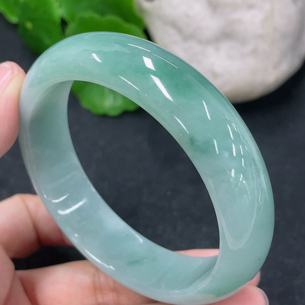 HKHQ jadeite round bangle in size 54.7 with a weight of 57.3g, showcasing smooth, polished jadeite surface and elegant craftsmanship.