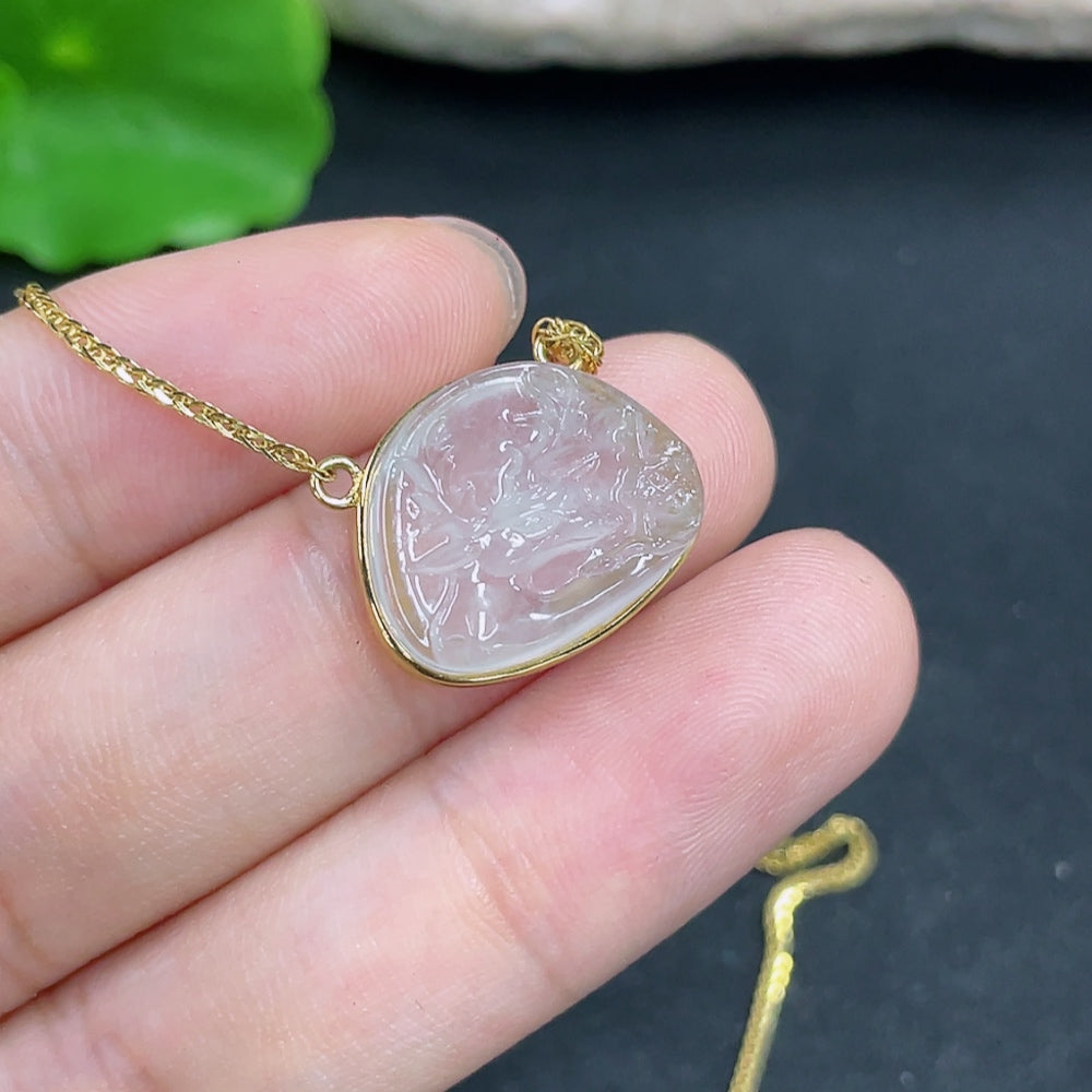 Jadeite pendant with 18K gold setting on a chain, jewelry piece featuring a polished green jadeite gemstone.