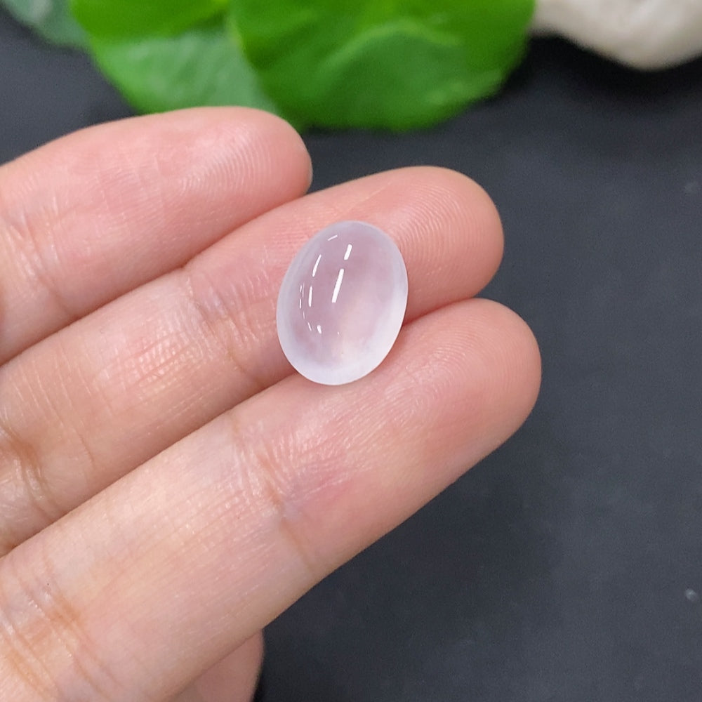 Small HKHQ jadeite cabochon jewelry stone, 1g, showcasing smooth, polished green jade with natural translucence.