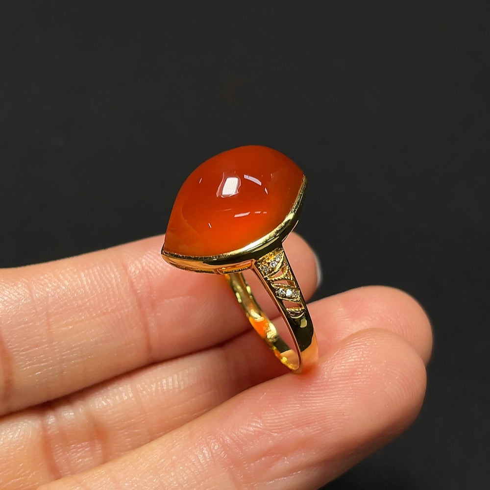18K gold Southern Red Agate ring with diamond accents, featuring a bold red gemstone and intricate band design.