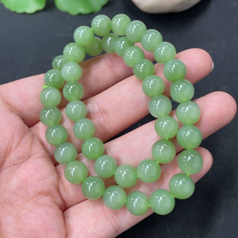 Hetian jade bead necklace with 7.6mm jade beads, weighing approximately 33.6g, featuring smooth, polished green jade stones.