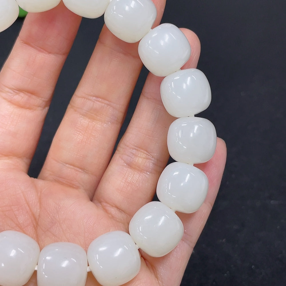 Hetian jade bracelet by HKHQ featuring smooth, polished jade stones, weighing 60.5 grams, showcasing elegant craftsmanship.