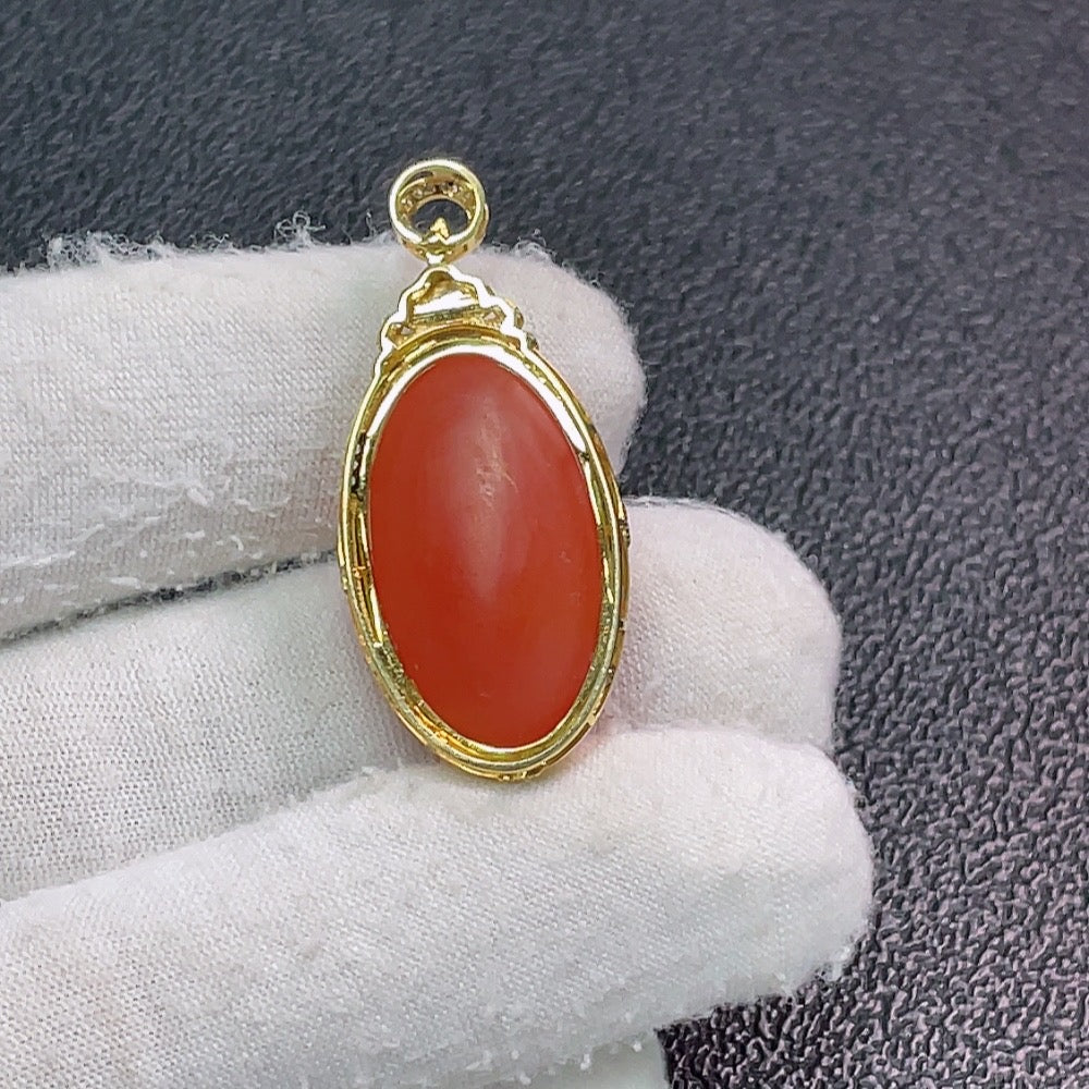 Red agate pendant with diamond accents from HUILIU HQ, featuring a polished gemstone and sparkling diamond details.