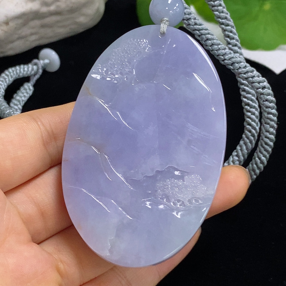 Jadeite pendant featuring a landscape design with a rope necklace, weighing approximately 110.3g, by HKHQ.